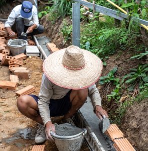 bricklaying. construction worker building a brick wall.