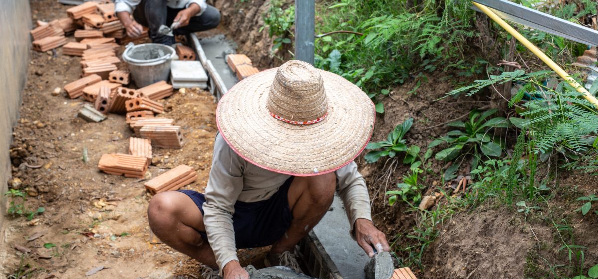 bricklaying. construction worker building a brick wall.